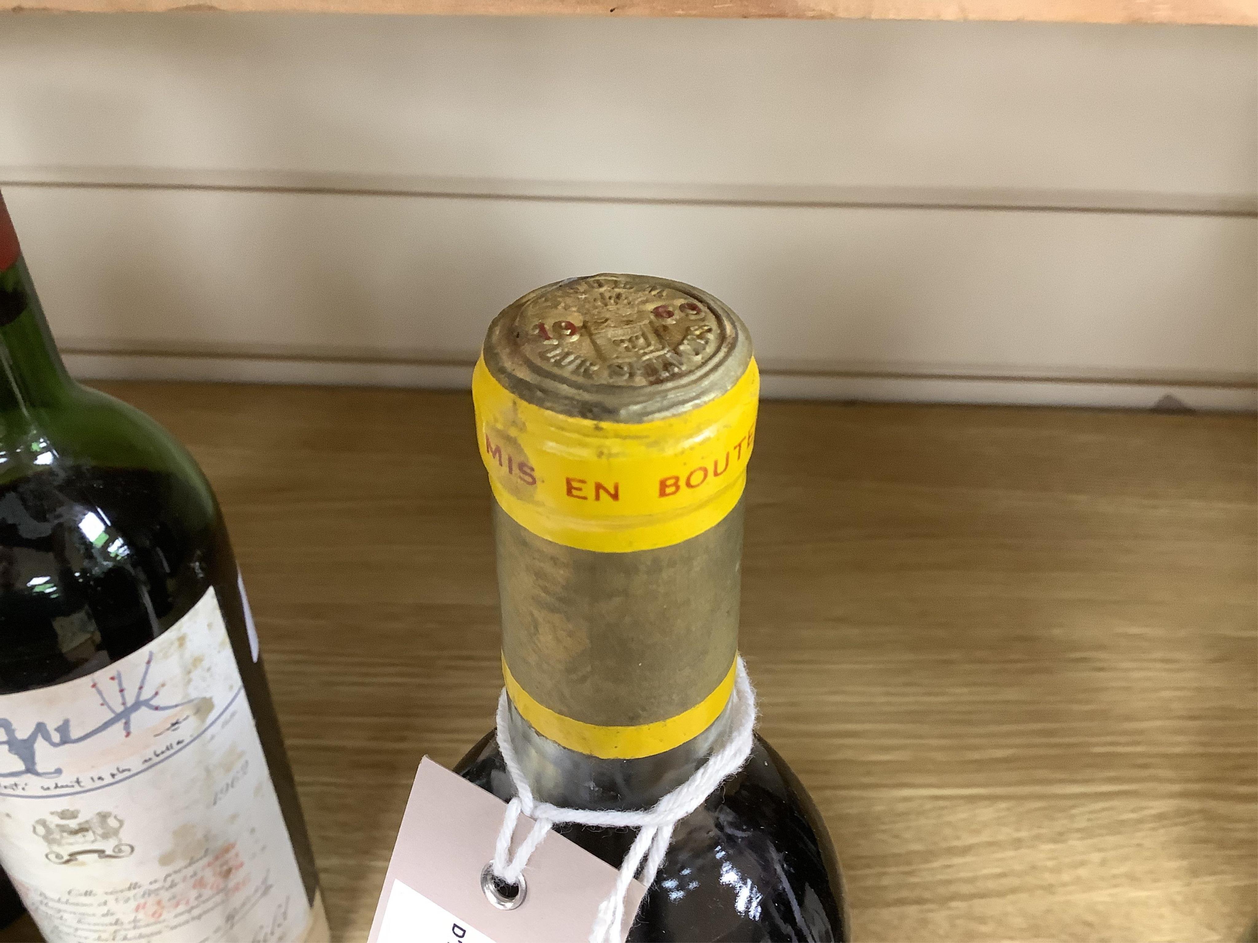 A bottle of Chateau d'Yquem, 1969. Condition - fair, level just above mid shoulder, label poor